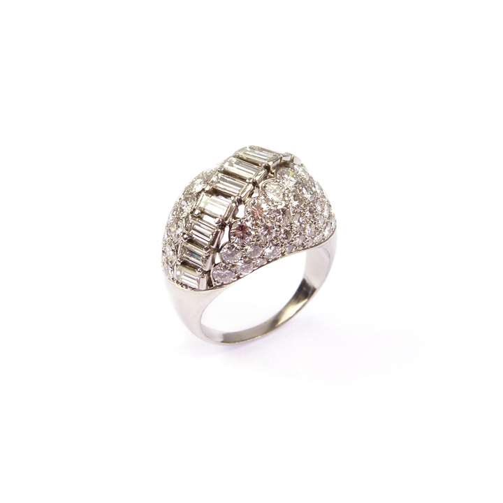Bombe shaped diamond cluster ring with round brilliant and baguette diamonds